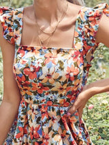 Vestido Modelo Acinturado Rodado Curto Estampa Floral Costas Nuas com Laço Alça de Babado
